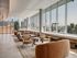 Luxurious lounge area with modern seating, large windows, and stunning city views.