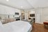 Modern studio apartment with open kitchen, cozy living area, and stylish workspace. Bright interior features sleek appliances and elegant decor.