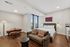 Elegant studio apartment with a cozy sleeping area, modern seating, and chic dining nook, featuring large windows with city views.