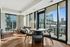 Sleek urban apartment with large windows showcasing stunning city views, featuring a cozy living area with modern furniture and abundant natural light.