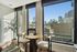 Bright and modern corner apartment with stunning cityscape views, featuring stylish decor and abundant natural light.