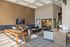 Luxurious lounge area with elegant decor, featuring a comfortable seating arrangement, stylish shuffleboard table, and modern art pieces.