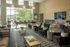 Luxurious lounge with modern seating, large windows, and elegant d&eacute;cor, offering abundant natural light and a sophisticated ambiance.