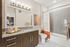 Elegant modern bathroom featuring sleek vanity with granite countertop, stylish lighting, and tasteful decor.