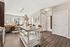 Contemporary open-plan kitchen and living area featuring cozy seating, elegant decor, and modern wooden flooring.
