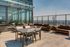 Luxurious rooftop terrace with modern seating and panoramic city views, perfect for entertaining and relaxation.