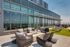 Luxurious rooftop terrace with stylish seating, a fire pit, and stunning city views, perfect for relaxation and entertaining.