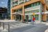 Modern urban apartment exterior with sleek architecture and vibrant sculpture, featuring spacious balconies and a contemporary design.