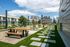Modern rooftop terrace with stylish seating, vibrant greenery, and stunning city skyline views.