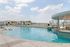 Luxurious rooftop pool offering stunning skyline views with ample lounge chairs for relaxation.