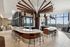 Luxurious contemporary Cafe with sleek bar counter, stylish pendant lighting, and expansive city views through floor-to-ceiling windows.