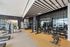 Modern fitness center with state-of-the-art gym equipment, large mirrors, and an open, welcoming design.