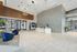 Modern apartment lobby with elegant lighting, stylish seating, and a sleek reception area, showcasing contemporary design.