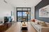 Chic urban living room with modern decor, large windows showcasing a stunning city view, and a cozy atmosphere.