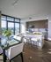 Elegant open-concept kitchen and dining area with modern appliances, sleek countertops, and panoramic city views.
