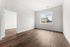 Bright and spacious room featuring sleek hardwood flooring and a large window with a scenic view, perfect for a stylish living area.