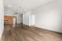 Modern open-concept living space featuring sleek hardwood floors, high ceilings, and a stylish kitchen with stainless steel appliances.