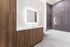 Elegant bathroom featuring modern wood cabinetry, sleek tile accents, and a contemporary illuminated mirror.