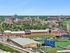 Vibrant cityscape featuring a dynamic sports complex, lush greenery, and impressive skyline for an inspiring urban living experience.