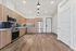 Modern kitchen with sleek stainless steel appliances, elegant wood cabinetry, and chic blue tile backsplash, featuring stylish pendant lighting.