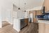 Modern kitchen with elegant wood cabinetry, a sleek island with pendant lighting, stainless steel appliances, and polished flooring.