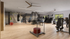 Modern fitness center with state-of-the-art equipment, including treadmills, weight machines, and a boxing area, bathed in natural light.