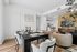Chic open-concept living and dining area with elegant decor, cozy chairs, and stylish dining setup, showcasing modern interior design.