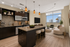 Modern open-concept kitchen and living area with sleek dark cabinetry, stylish pendant lighting, and large windows offering stunning city views.