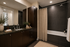 Elegant bathroom featuring dark wood cabinetry, sleek countertops, chic decor, and a modern bathtub with a stylish shower curtain.