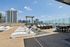 Luxurious rooftop lounge with stylish sun loungers, comfortable seating, and a breathtaking city view.