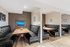 Chic dining area featuring sleek black leather booths and modern wooden tables, perfect for intimate gatherings in a stylish setting.