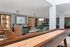 Modern game room with elegant seating, ambient lighting, and a stylish shuffleboard table, perfect for social gatherings.