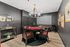 Sophisticated poker room with a stylish round table, elegant decor, and themed artwork, perfect for entertaining.
