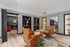Elegant living area with chic leather seats, decorative shelving, and warm lighting, perfect for relaxation and style.