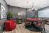 Chic gaming room with elegant poker table, stylish chandelier, and plush red seating, perfect for entertainment enthusiasts.