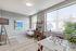 Bright and modern living space with large windows, stylish decor, and a cozy dining area, perfect for urban living.
