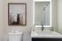 Modern bathroom featuring elegant fixtures, a unique llama artwork, and luxurious amenities for a serene retreat.