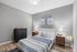 Modern bedroom with elegant decor, featuring a stylish bed, sleek side tables, and soothing gray walls.