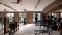 Spacious and modern gym with state-of-the-art workout equipment, natural lighting, and scenic outdoor views.