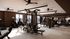 Modern fitness center with state-of-the-art equipment, featuring treadmills, weight machines, and large windows for abundant natural light.
