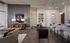 Elegant open-concept living area featuring stylish decor, a modern kitchen with bar seating, and sophisticated lighting.