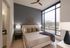 Elegant bedroom with modern decor and large windows offering a scenic view, featuring a cozy bed with plush pillows and stylish wall art.