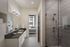 Contemporary bathroom with elegant vanity, modern fixtures, and an inviting view into a cozy bedroom.