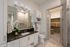 Elegant bathroom with modern fixtures, dual-sink vanity, and spacious walk-in closet featuring luxury design and abundant storage.