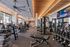 Modern fitness center with state-of-the-art gym equipment, mirrored walls, and natural lighting.