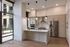 Modern kitchen with sleek stainless steel appliances, elegant pendant lights, and expansive windows for natural light.