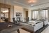Elegant common area with modern design, featuring a cozy seating arrangement, pool table, and floor-to-ceiling windows offering city views.