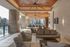 Modern outdoor lounge area with elegant seating, stylish ceiling fans, and expansive city views, ideal for relaxation and entertaining.