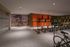 Modern indoor bike storage area featuring vibrant orange lockers and artistic wall mural, offering convenient and secure storage solutions.
