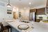 modern, open-concept kitchen and dining bar area featuring white quartz countertops, stainless steel appliances, and dark wood-finish cabinetry